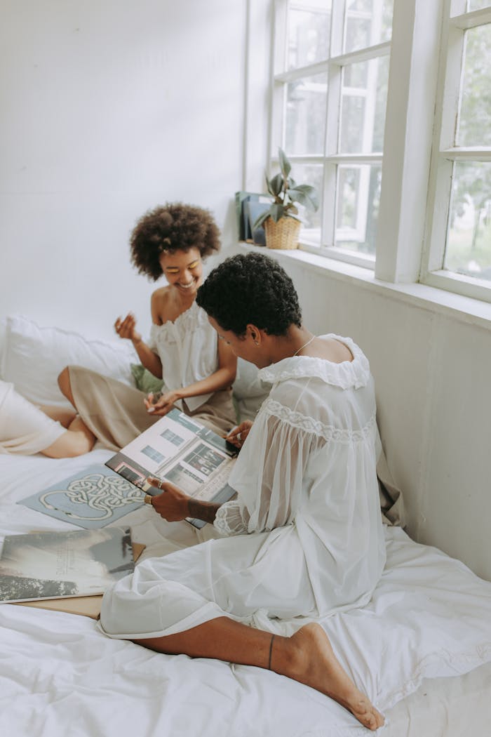 The Art of Drawing Readers In: Your attractive post title goes here Two women relaxing indoors, sharing music and spending quality time together.
